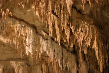 A stalagmite is a type of rock formation that rises from the floor of a cave due to the accumulation of material deposited on the floor from ceiling drippings.