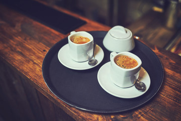 Waiters carrying plates with food, in a restaurant.