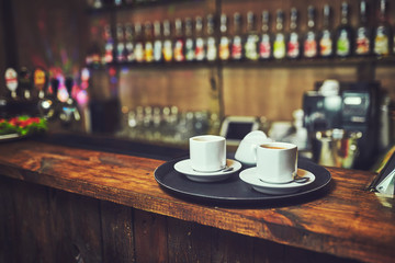 Waiters carrying plates with food, in a restaurant.