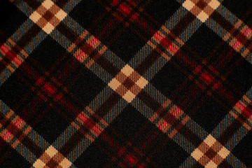 Checkered fabric for the costume. Texture of wool fabric for sewing clothes. Checkered colorful fabric creates a background. Fashion, style and design of textiles.