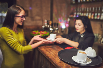 Waiters carrying plates with food, in a restaurant.