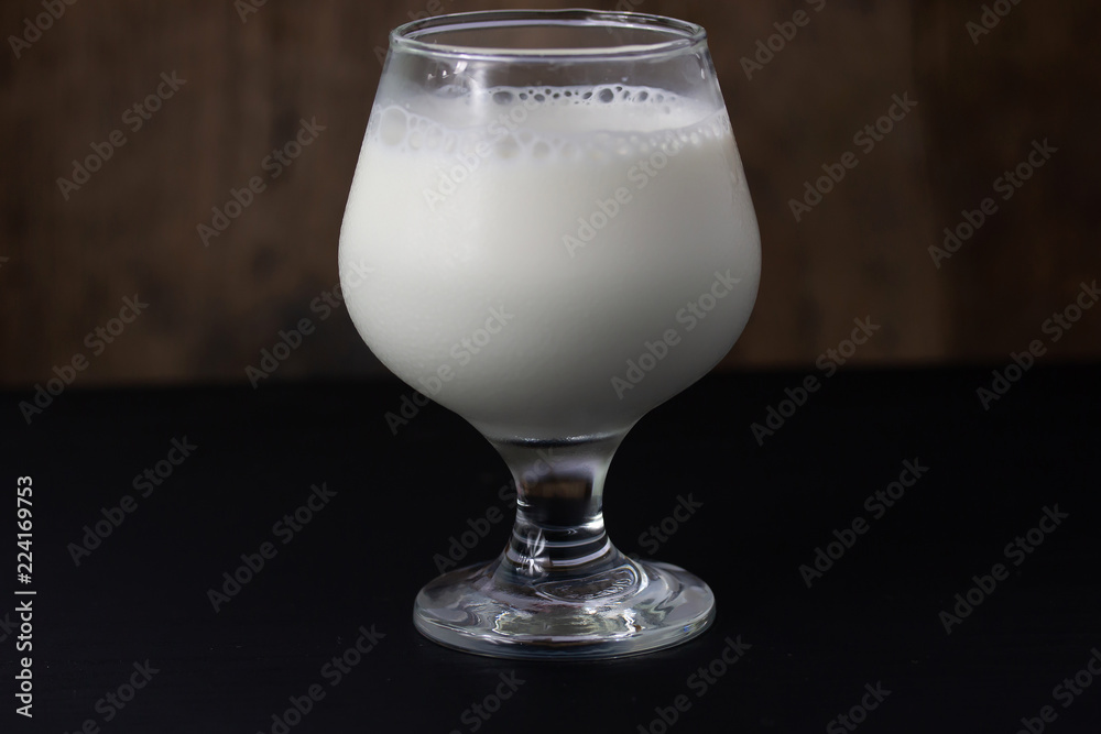 Wall mural fresh milk in a glass isolated on table background