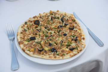 Mixed vegetable pizza at resturant table setting