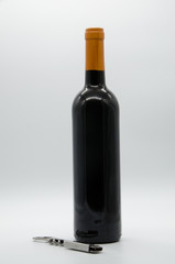 bottle of wine with a corkscrew