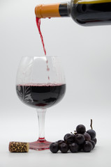 bottle of wine with grapes with glass and cork