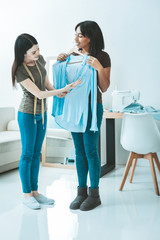 Professional consultation. Competent designer keeping centimeter stripe around neck and enjoying her job