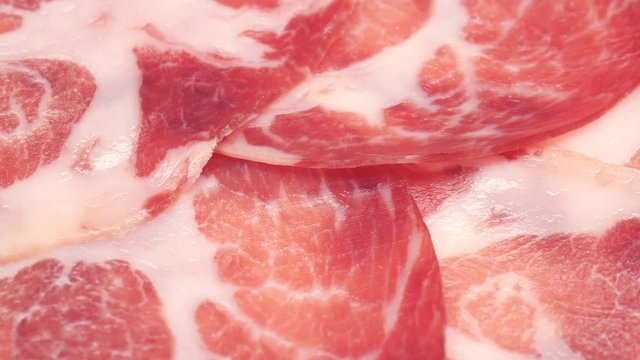 UHD closeup shot of the delicious thin sliced Coppa or Capicola ham on a turntable