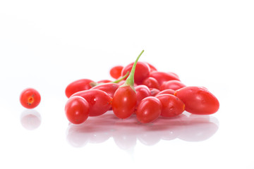 red ripe goji berry on a branch isolated on a white