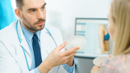 Plastic / Cosmetic Surgeon Shows Female Patient Breast Implant Samples for Her Future Surgery....