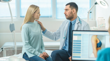 Friendly Doctor Consoles Female Patient, Lightly Touching Her Shoulder in Consolation. Kind Gestures from Professional. Nurse Working on Personal Computer Analyses Data for Liposuction Procedure.