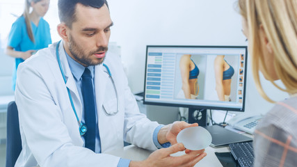 Plastic / Cosmetic Surgeon Shows Female Patient Breast Implant Samples for Her Future Surgery....