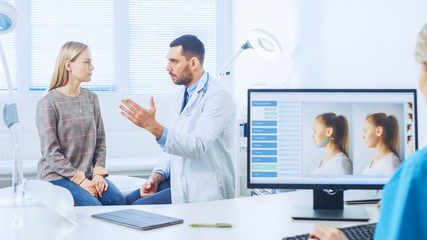 Fototapeta premium Plastic / Cosmetic Surgeon Consults Woman about Facelift Surgery. Nurse Works on Computer that Shows Types of Facelift, Forehead Lift, Cheek Bones and Nose Correcting Procedures Available.