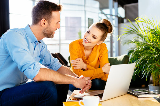 People during business meeting. Two creative workers chatting over coffee in stylish cafe