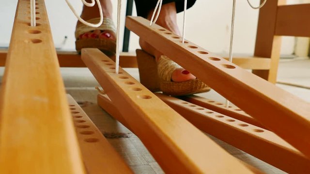 Woman weaving a rug on a wooden loom, 4k Video Clip
