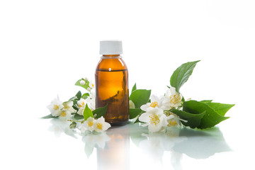 Obraz na płótnie Canvas Essential aroma oil with jasmine on a white background