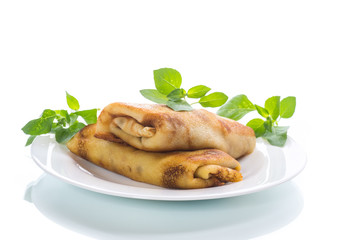 fried thin pancakes stuffed on a plate