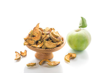 Dried apples in a bowl with a fresh apple