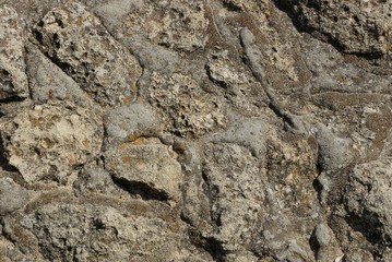 gray brown texture of stones and cement on the wall