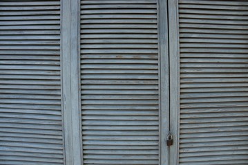 gray wooden background of thin boards in a lattice on the door