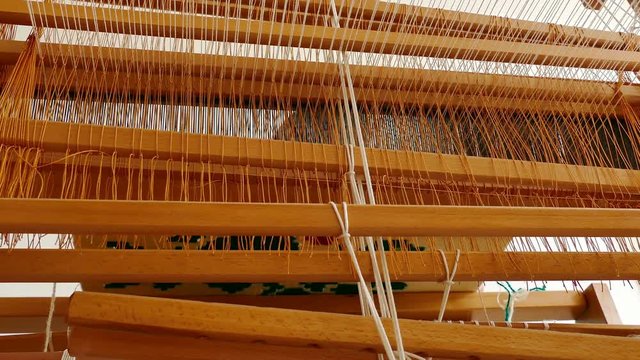 Woman weaving a rug on a wooden loom, 4k Video Clip