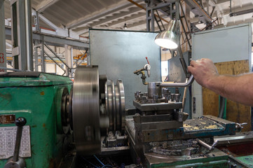 Processing of metal on the machine. Turning work in production.