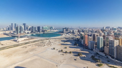 Aerial skyline of Abu Dhabi city centre from above timelapse