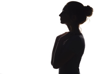 silhouette of a young graceful woman on a white isolated background, face profile of a beautiful girl