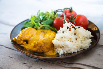 Rice and chicken on white plate