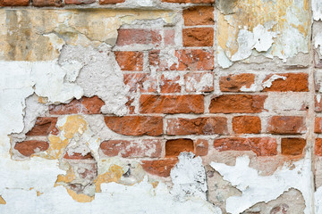 texture of a old brick wall with traces of gray plaster