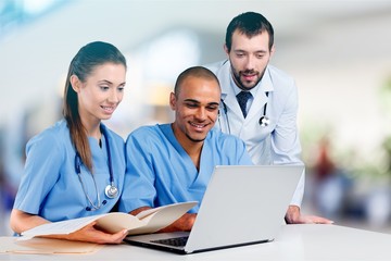Female and male scientists in glasses working with microscope
