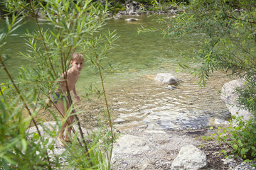 Boy getting out of the river