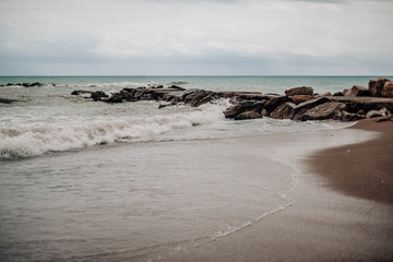 Fototapeta na wymiar Stormy beach with waves approaching