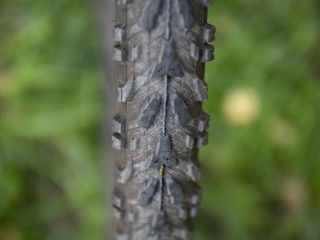Picture of front bicycle wheel closeup with worn tire shallow dof 