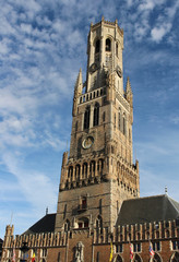 Main facade of Belfry of Bruges in the evening on a sunny day. The centre of Bruges, Belgium.