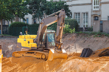 Tractor excavator with bucket at the city street