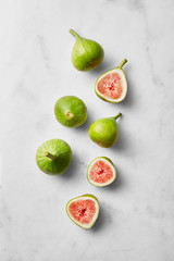Figs isolated on a marble background. Fresh fruit viewed from above. Top view