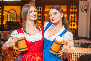 Young beautiful girl with glasses of beer in hands