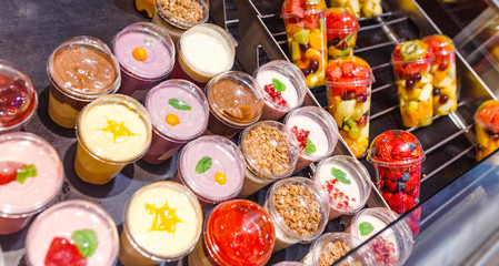 assortment of yogurt on display for sale at convenience store