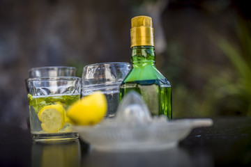 Mojito drink in a transparent glass on wooden surface with white rum,soda,lemon juice,fresh mint leaves,ice cubes and sugar,Close up shot or top shot.