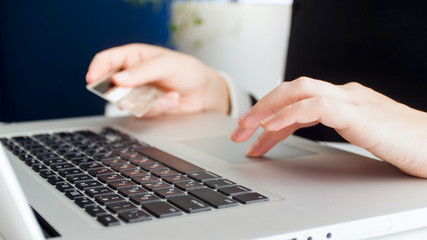 Closeup photo of young woman making online purchases and paying with credit card