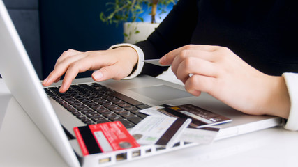 Closeup photo of woman checking her online banking accounts on laptop