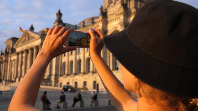 Female Traveler Photographing Tourist Attraction With Mobile Phone. Travel Around Europe.