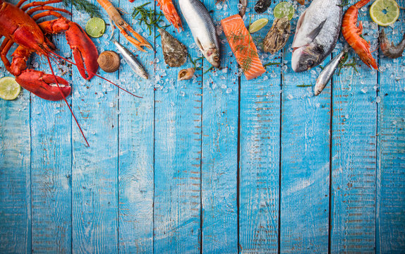 Fresh tasty seafood served on old wooden table.