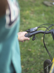 Fototapeta na wymiar Girl holding a Bicycle handlebar