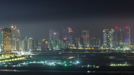 Fototapeta na wymiar Buildings on Al Reem island in Abu Dhabi night timelapse from above.