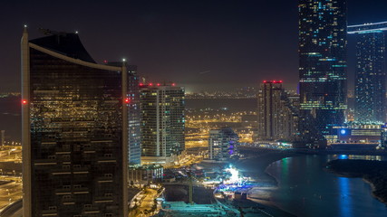 Buildings on Al Reem island in Abu Dhabi night timelapse from above.