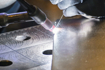 Metal welding process that uses a non-consumable tungsten electrode. Close-up.