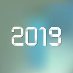 Origami 2019 symbol on a blue bokeh background.