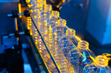 Bottle. Industrial production of plastic pet bottles. Factory line for manufacturing polyethylene bottles. Transparent food packaging.