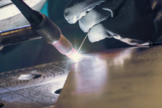 Metal welding process that uses a non-consumable tungsten electrode. Close-up.